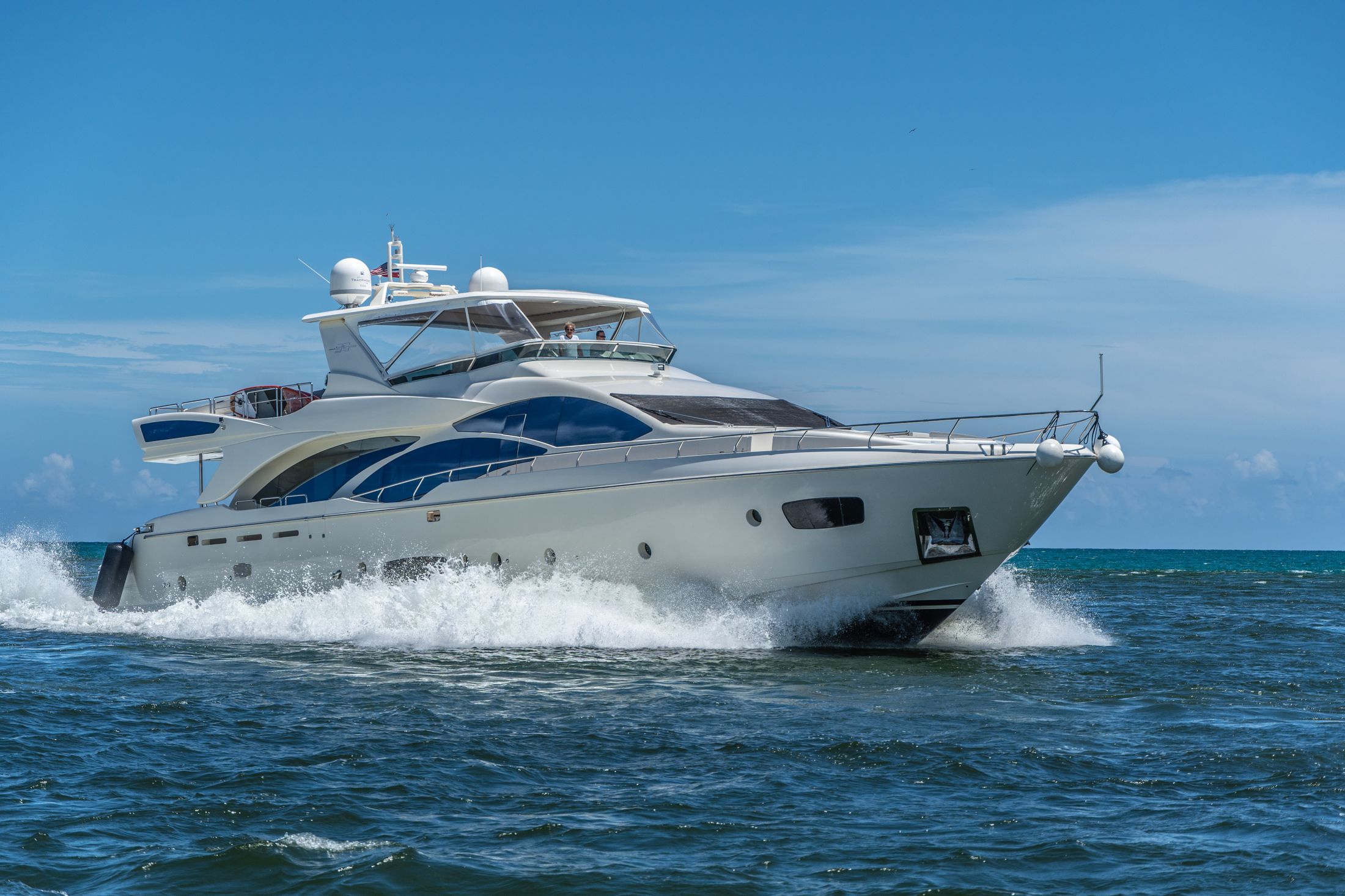 A contemporary luxury motor yacht cruising on blue water
